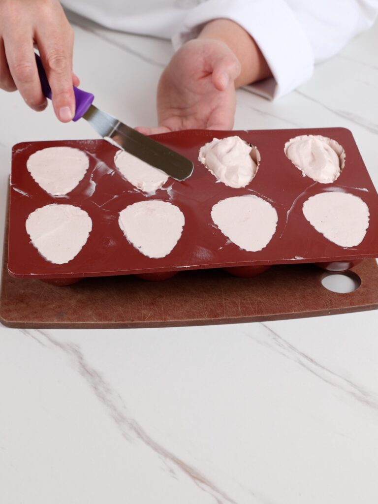 Assembling a viral strawberry dessert.