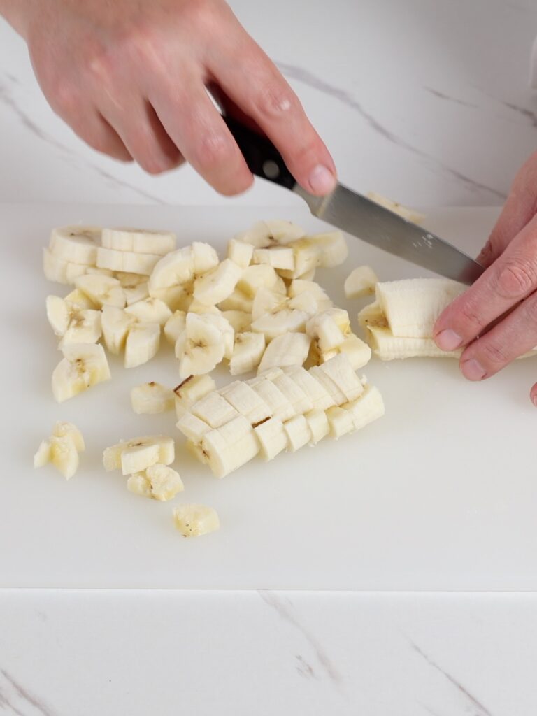 Cubes of banana on the cutting board.
