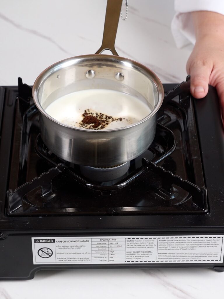Saucepan with heavy cream and instant coffee. 