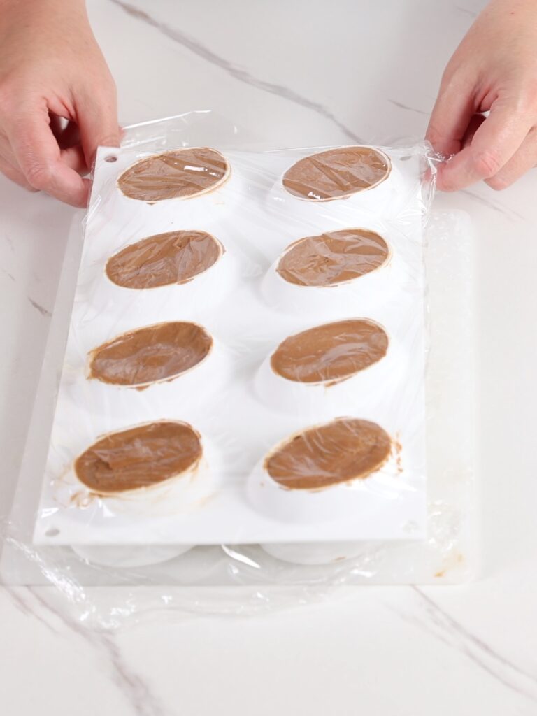 Silicon mold covered with plastic wrap. 