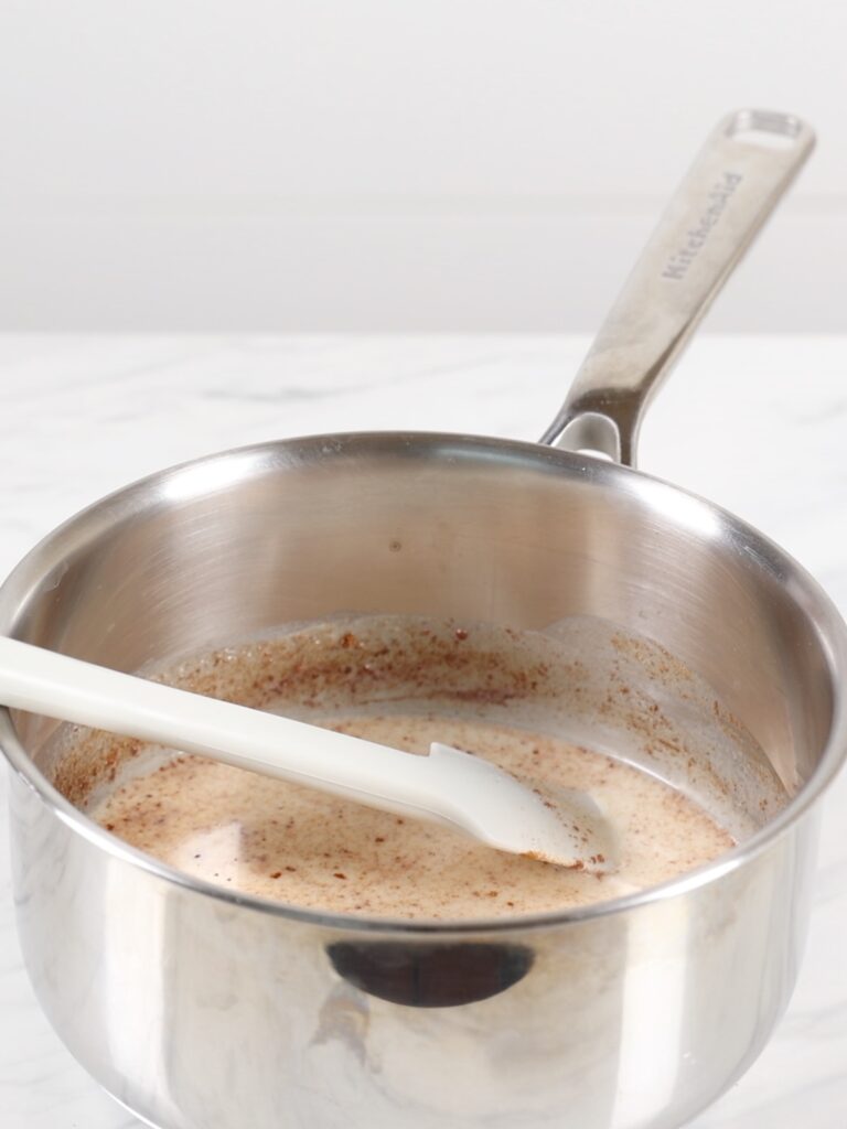 Saucepan with heavy cream and cinnamon. 