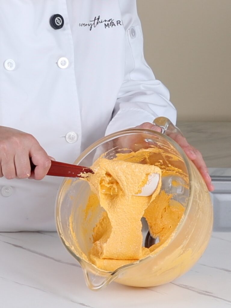 Folding macaron batter with a spatula. 