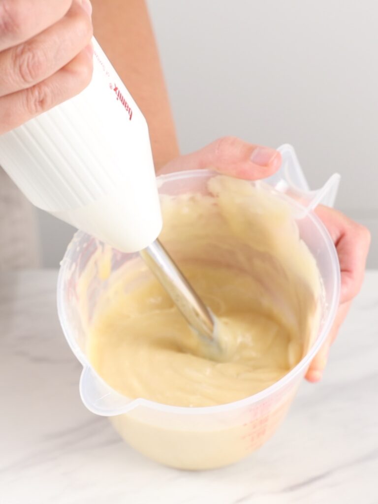 Emulsifying ganache with an immersion blender. 