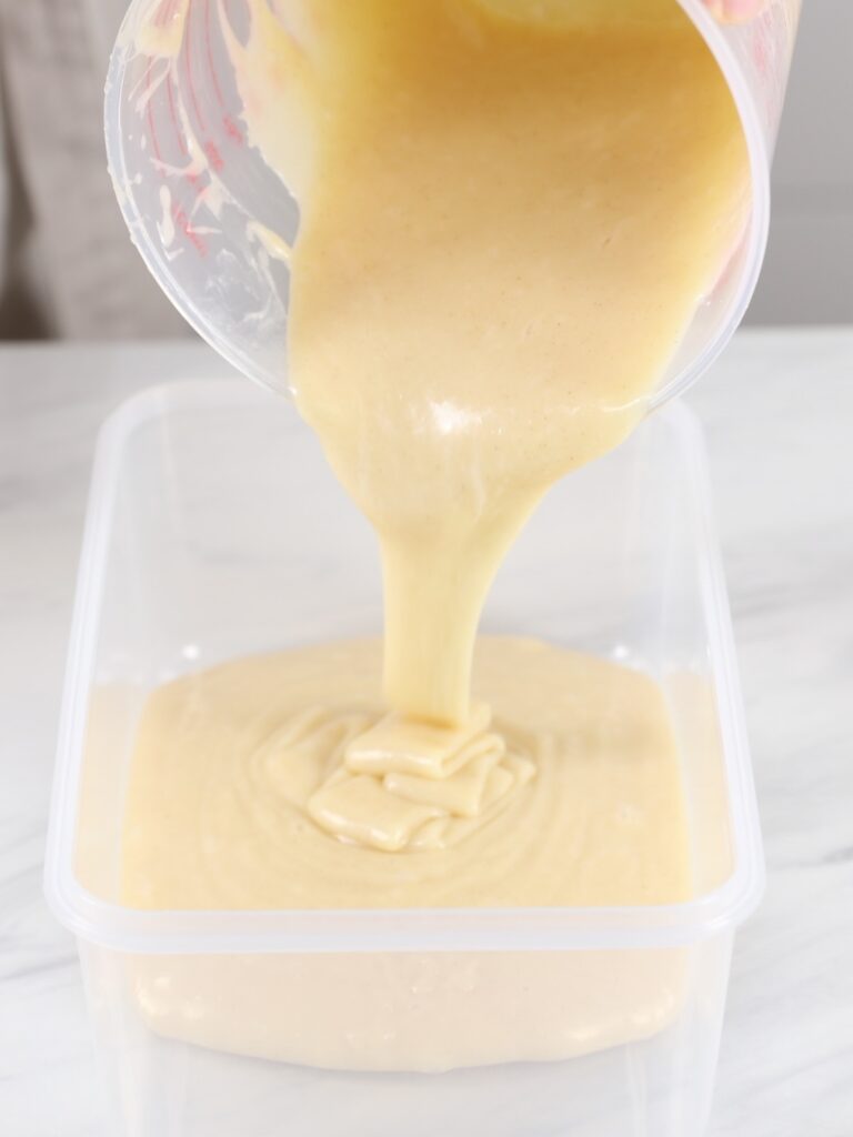 Pouring ganache into a flat container. 