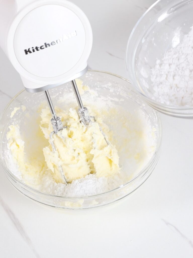 Butter and powdered sugar in the mixing bowl. 