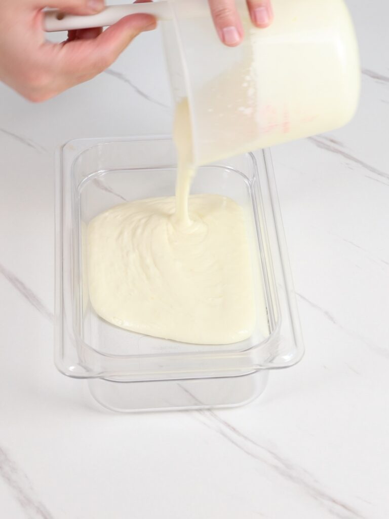 Pouring lemon ganache into a flat container. 