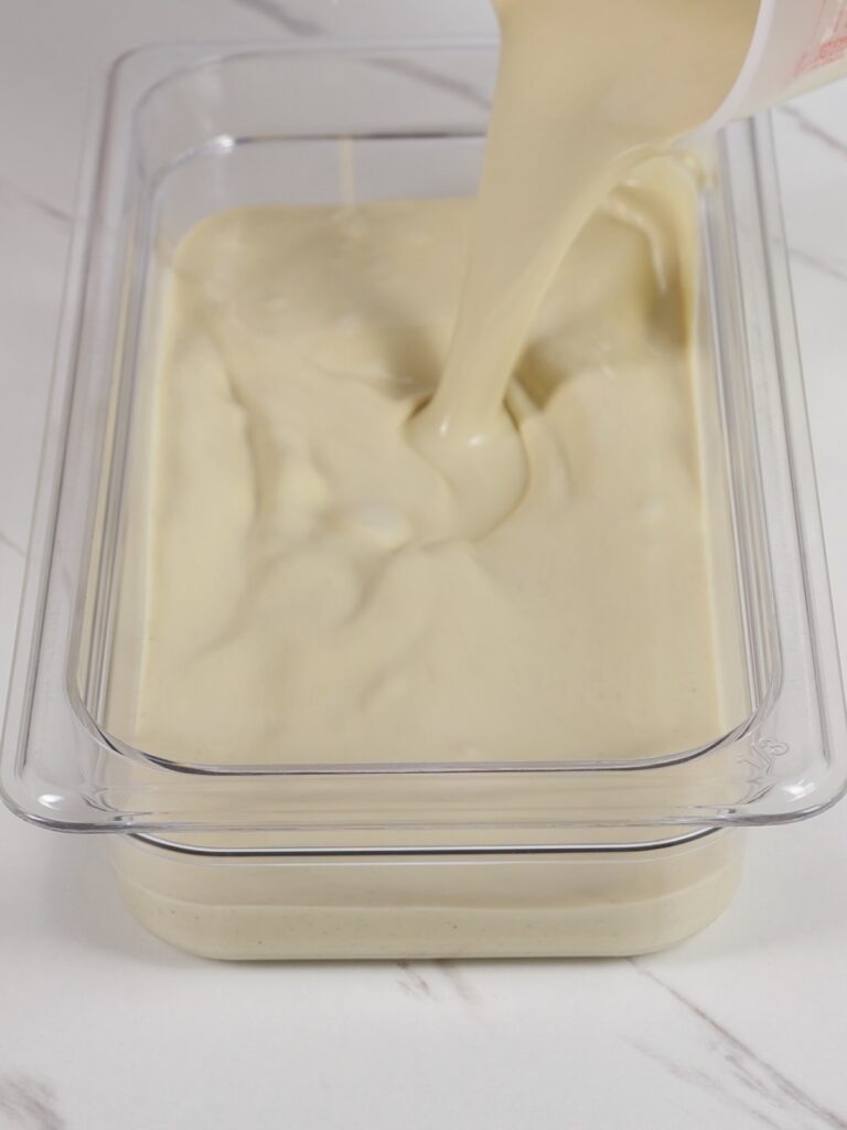 Transferring ganache into a flat container. 