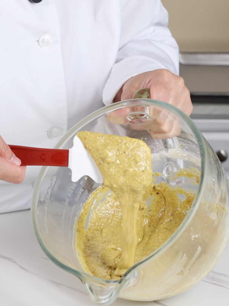 Pistachio cake batter in the mixing bowl. 