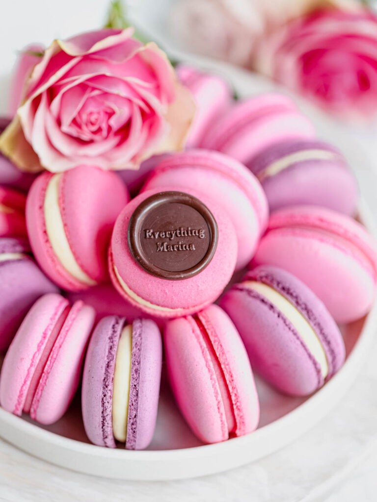 Pink macarons on the round plate. 