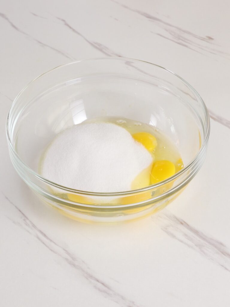 Eggs and sugar in the mixing bowl. 