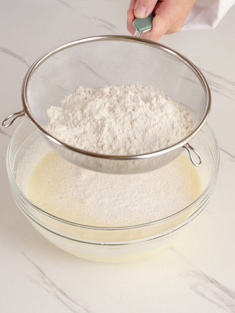 Sifting dry ingredients into a bowl. 